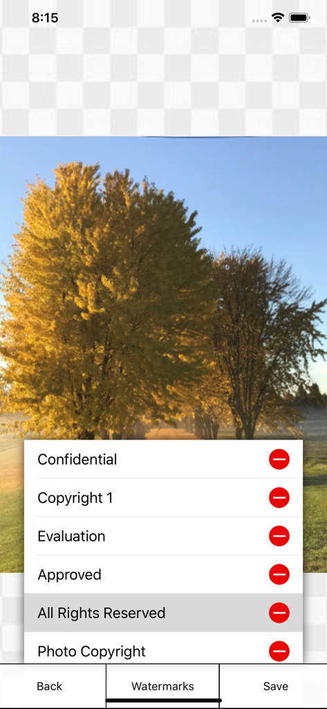 Interface of iWatermark Lite app showing a menu of watermark options like Copyright and All Rights Reserved over a photo of a tree