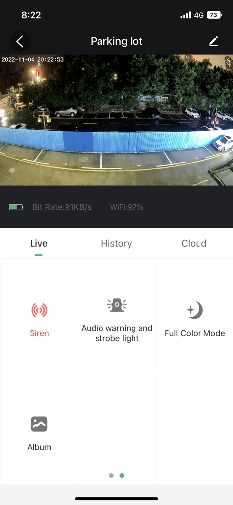 SV3C Cloud - SV3C Cloud app showing a live security camera feed of a parking lot at night with siren and lighting controls
