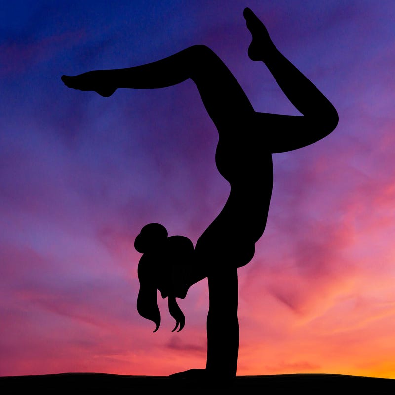a woman doing a handstand