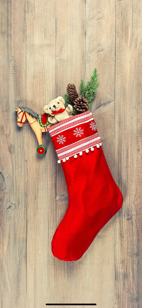Sound Touch-Christmas (School) - A red Christmas stocking with a teddy bear and pinecones on a wooden background