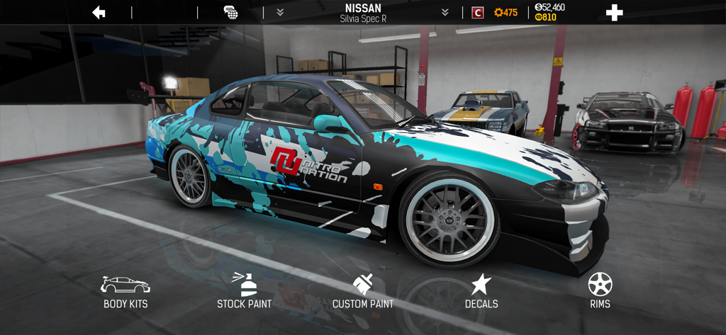 Nitro Nation: Drag Racing - A customized Nissan Silvia Spec R in the Nitro Nation garage showing options for paint decals and rims