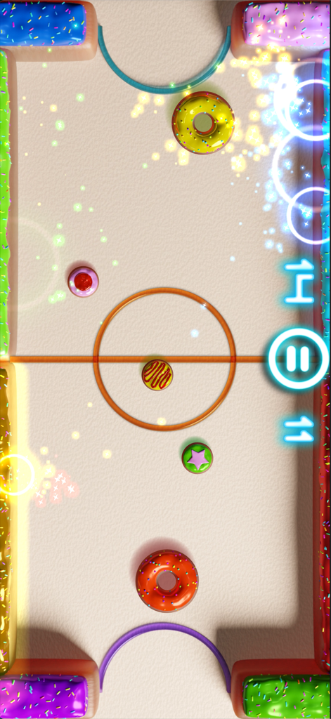 Jugabilidad de air hockey de Glow Hockey 2 con un tema de dona colorida y chispas