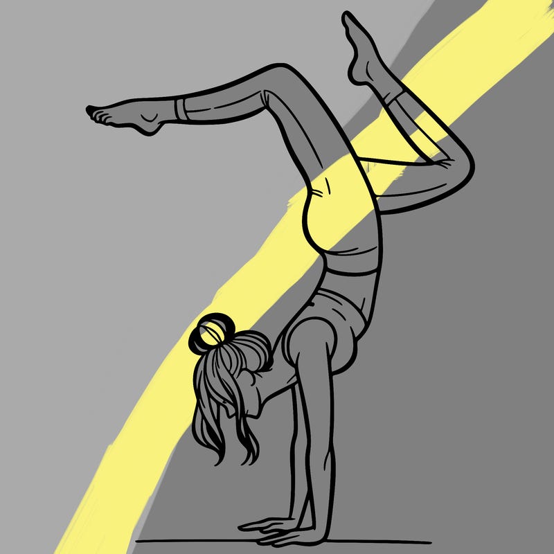 a woman doing a handstand