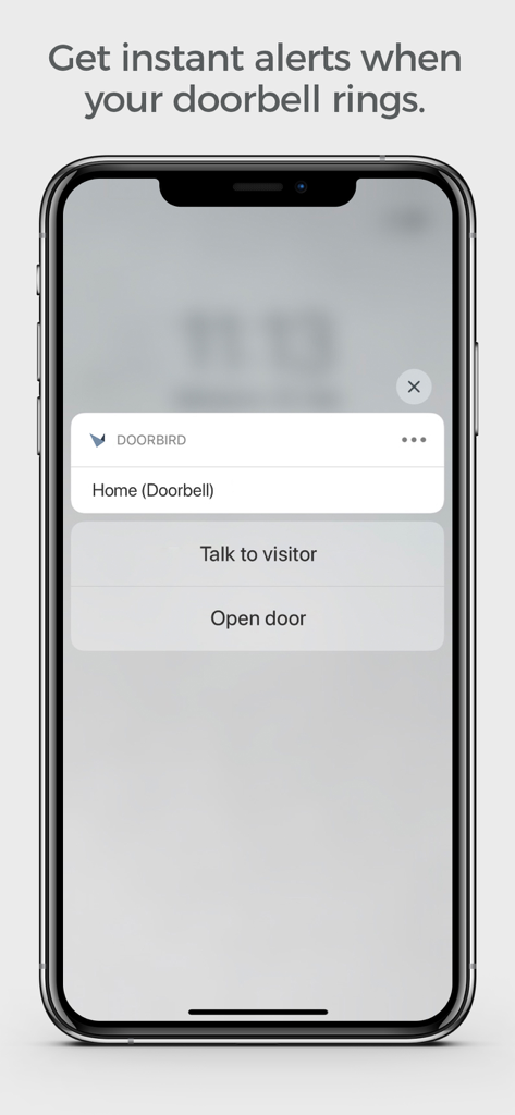 DoorBird app push notification on a smartphone screen showing instant doorbell alerts with talk and unlock options