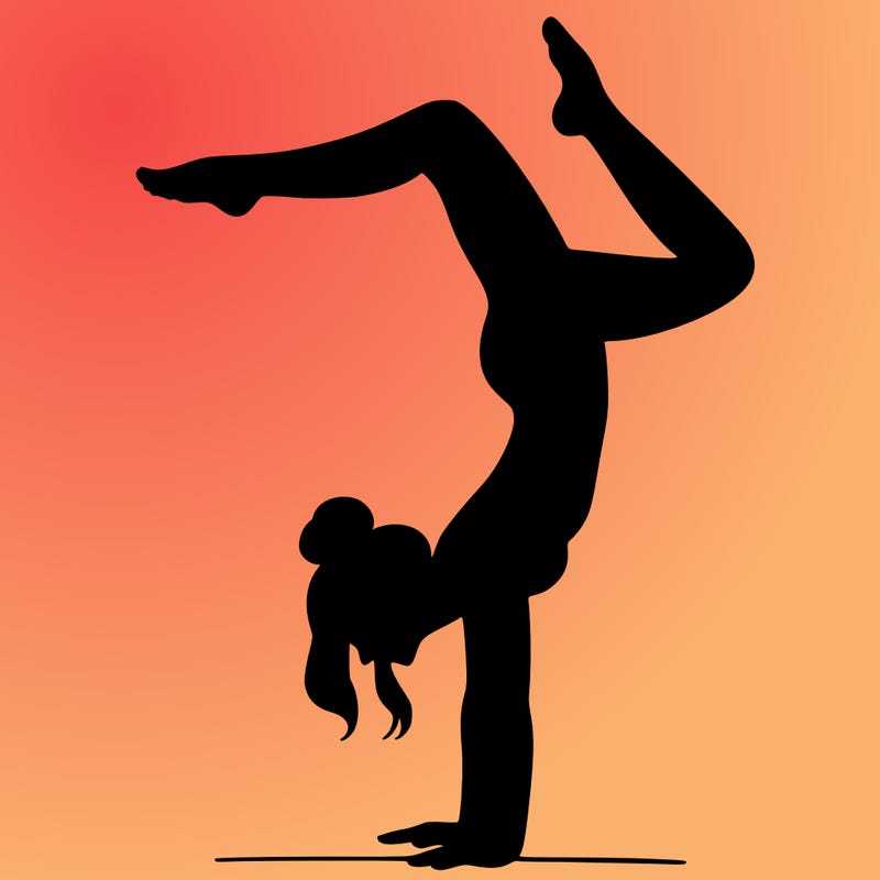 a woman doing a handstand