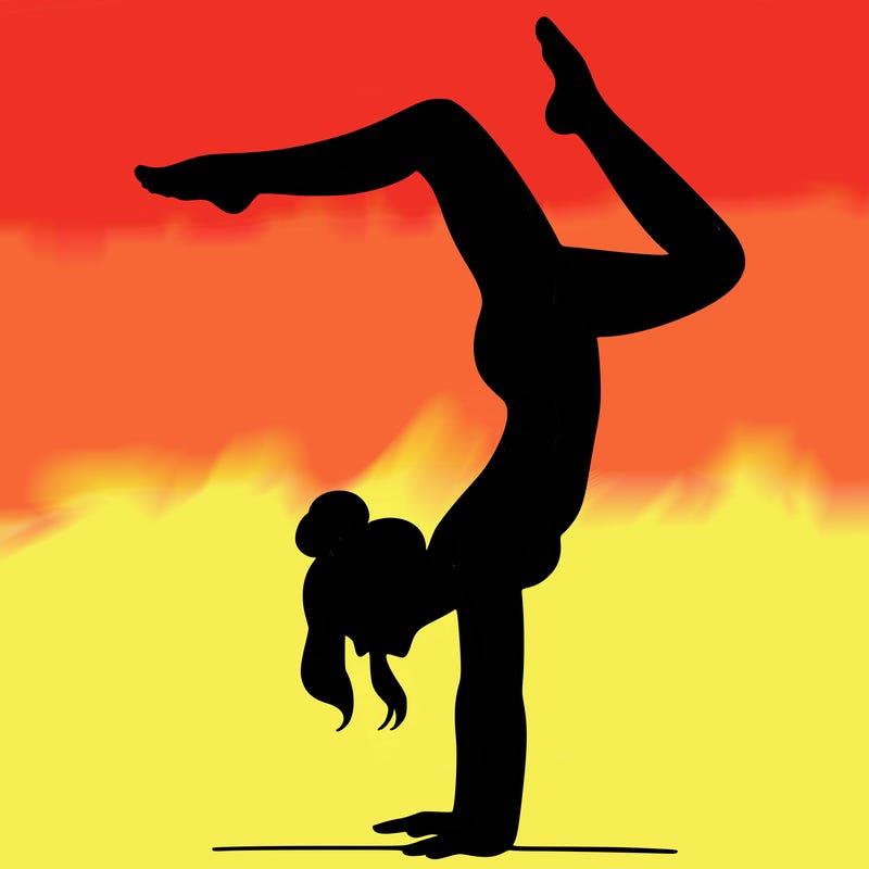 a woman doing a handstand