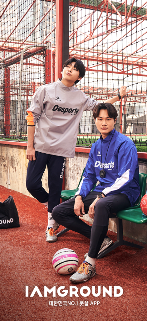 Two futsal players in athletic gear posing on a court with a soccer ball