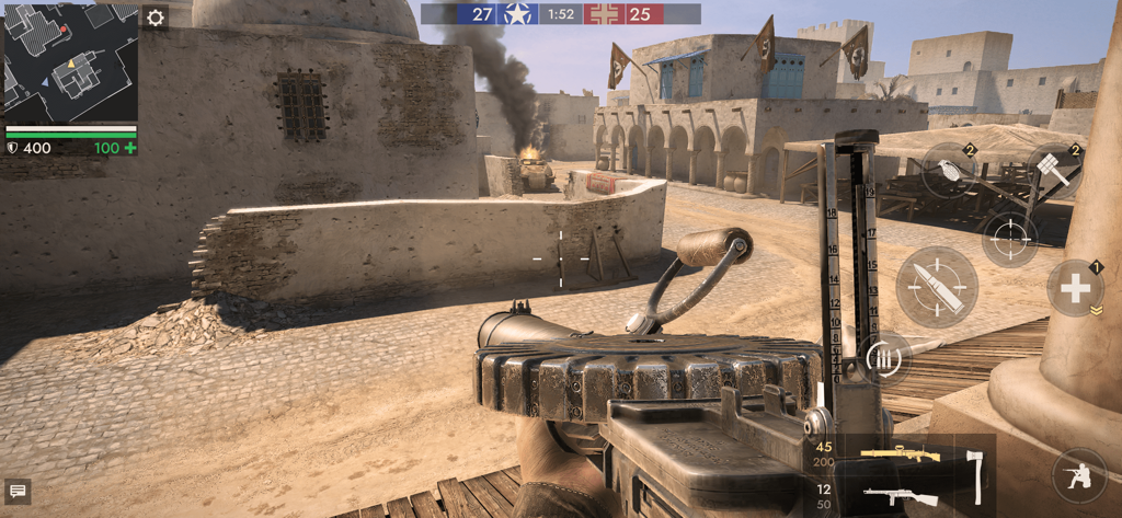 First person view of a player holding a machine gun in a World War II desert battle zone