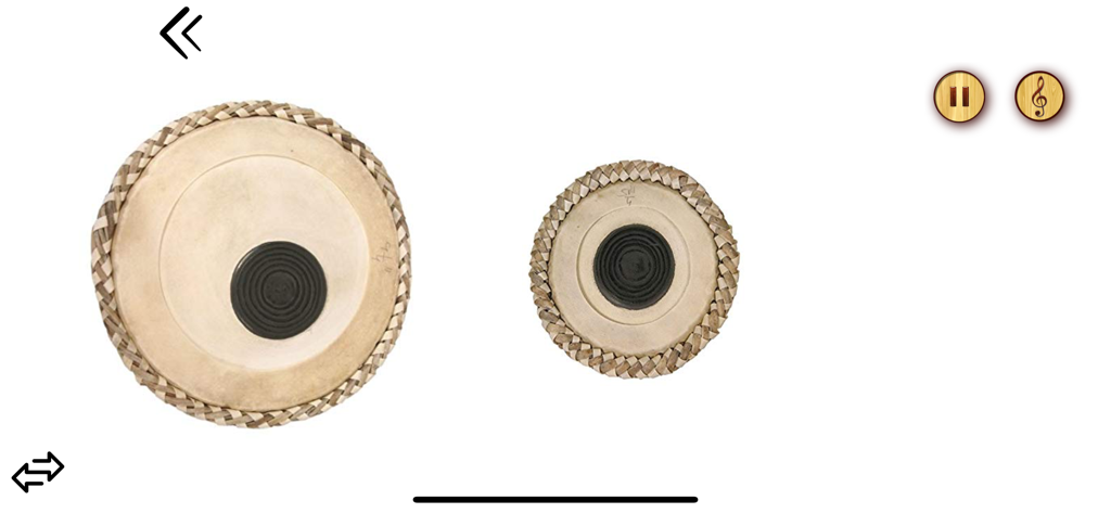 Tabla Drums Dhol Piano Guitar - A screenshot of the virtual tabla instrument within the app showing the two drum heads