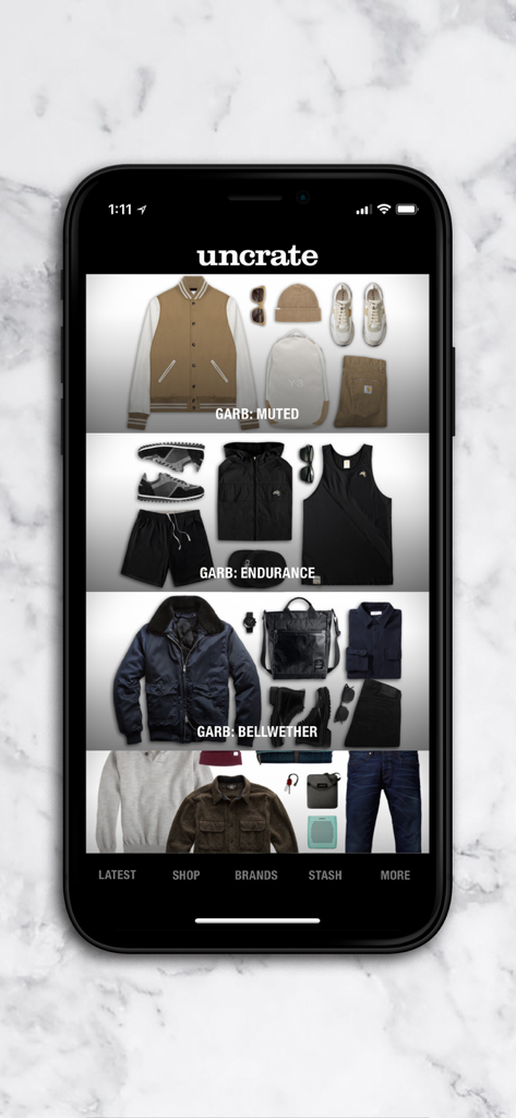 Uncrate mobile app interface showcasing curated fashion collections for men.