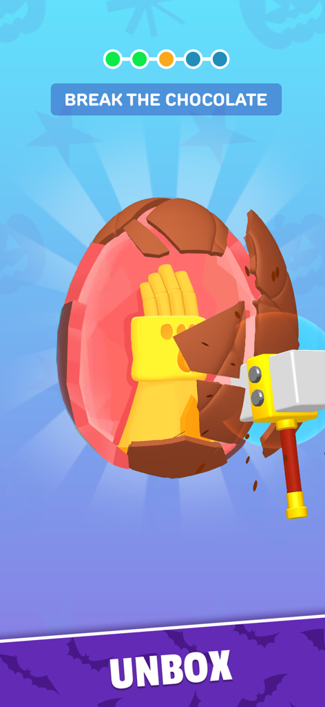 A hammer breaking a chocolate surprise egg to reveal a golden gauntlet toy inside.