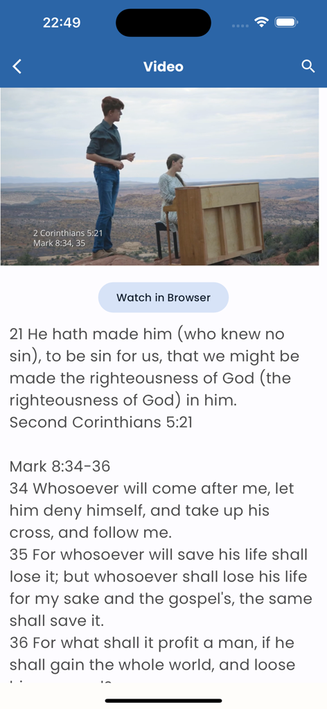 Scripture Singer - A mobile app screen showing a video of a musical performance in a desert landscape with Bible verse lyrics displayed below for memorization.