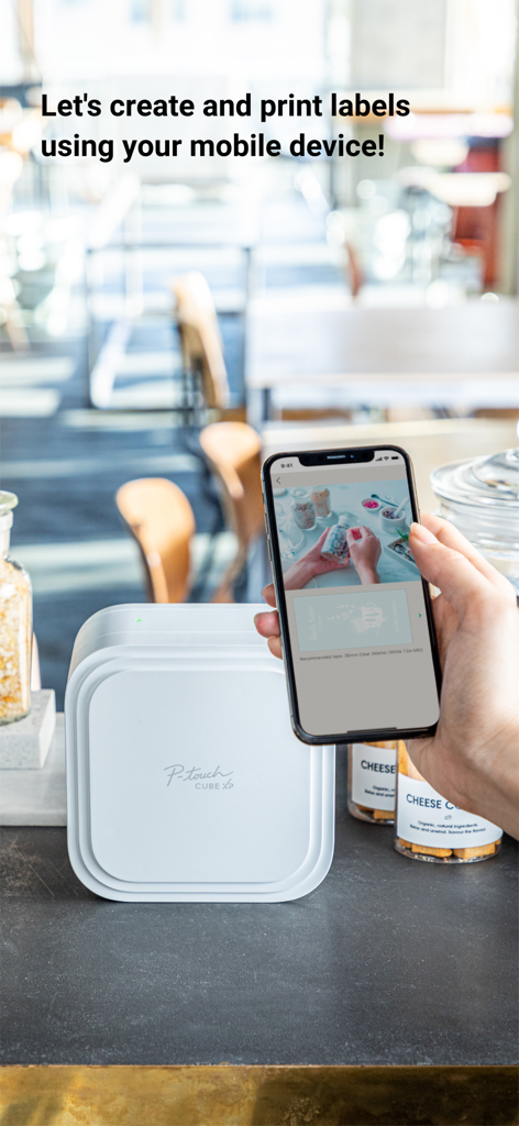 Brother P-touch Design&Print 2 - A person using the Brother P-touch Design and Print 2 app on a smartphone to design labels next to a P-touch CUBE XP printer.