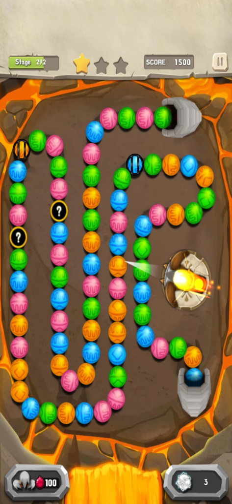 Gameplay of Marble Mission showing colorful marbles on a winding path in a lava themed level.