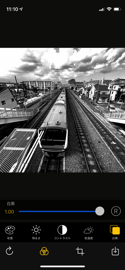 OneCam 2 mobile app interface showing a black and white photo of a train with editing sliders and effects