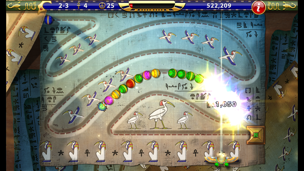 Luxor HD - Gameplay screenshot of Luxor HD showing colored marble chains on an Ancient Egyptian papyrus themed level
