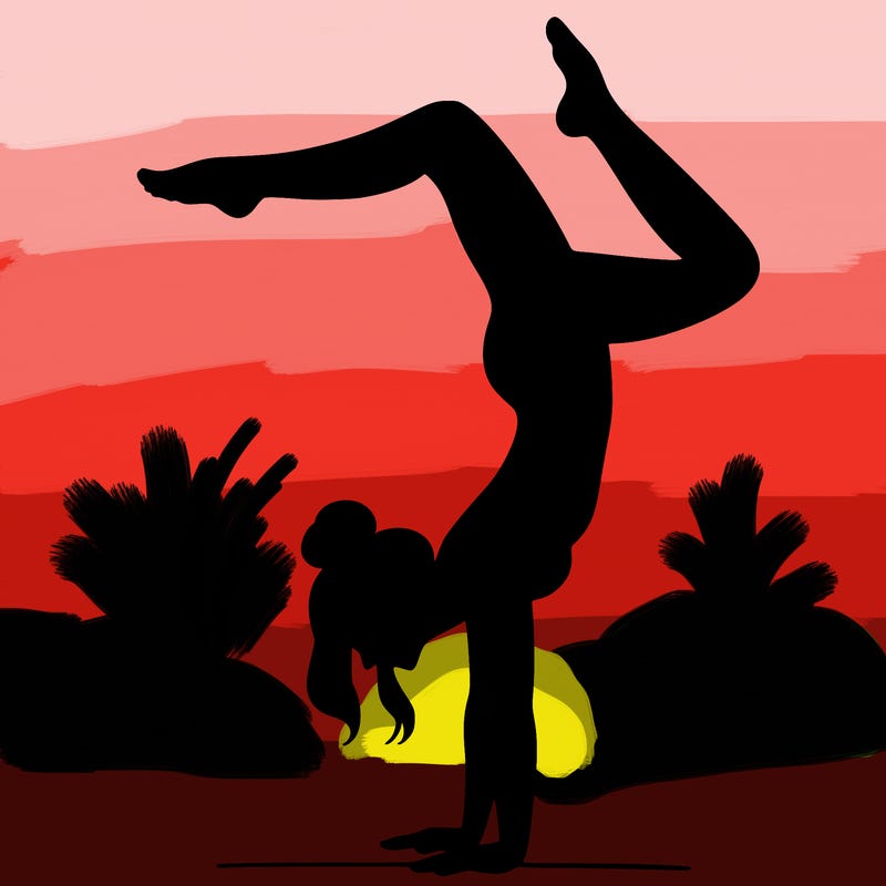 a woman doing a handstand