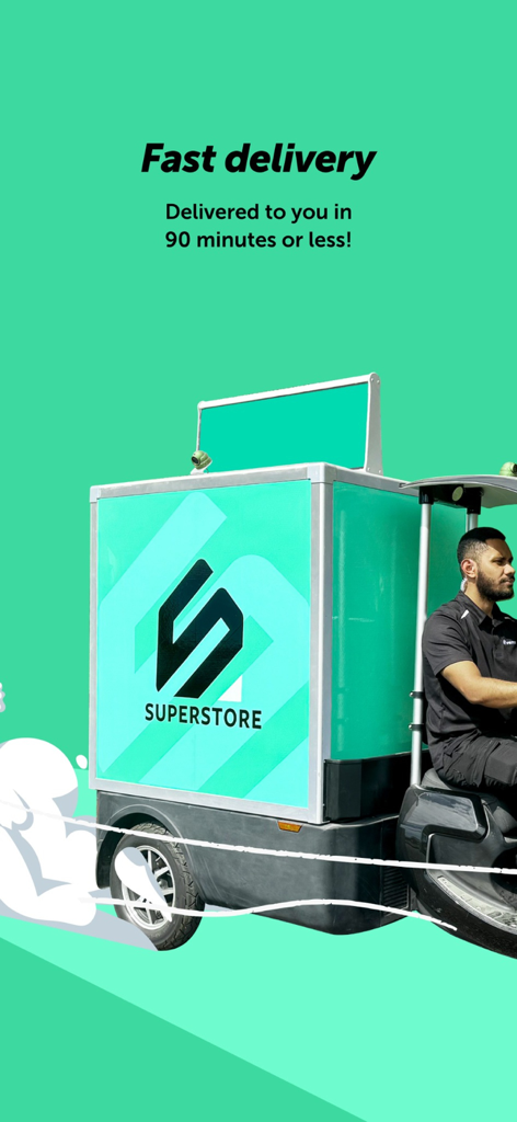 A driver on a Superstore Fiji branded electric delivery vehicle with text promising delivery in 90 minutes or less