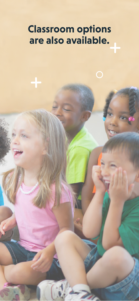 A group of diverse elementary students laughing and sitting together in a classroom setting