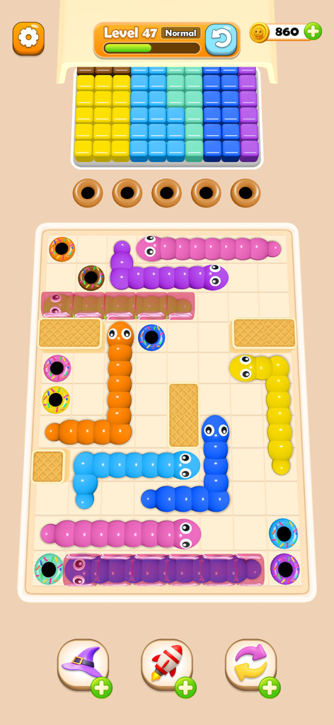 Worm Color Blast - Colorful squishy worms on a grid puzzle board with matching color donut holes in Worm Color Blast.