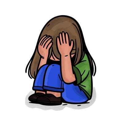 girl sitting down covering her head