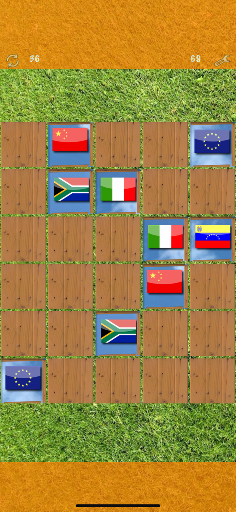 Pairs (Oh no! Another one!) - A memory matching game board with wooden tiles revealing different world flags on a green grass background