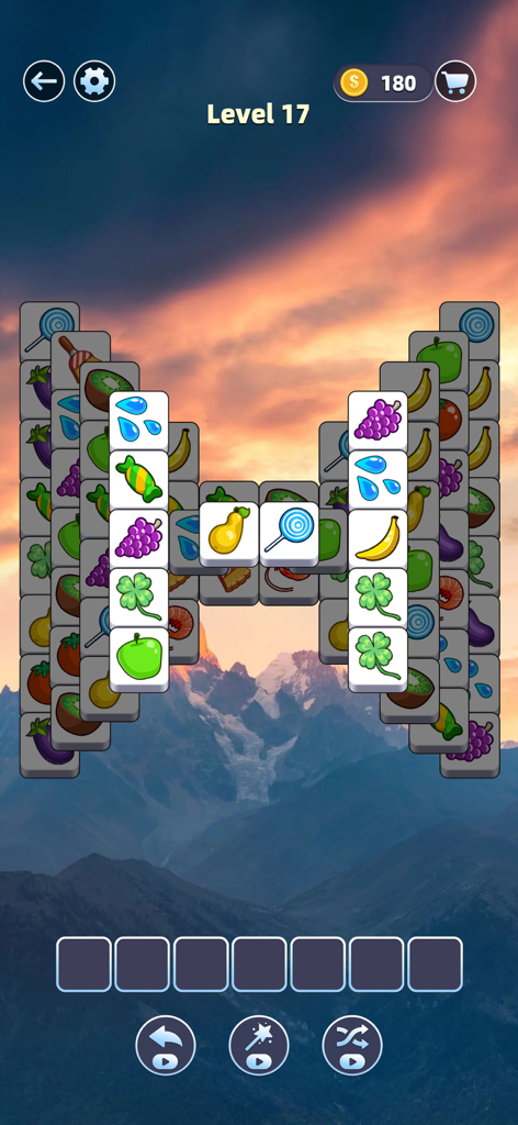 Tile Master Pro: Triple Match - Tela de jogo do Tile Master Pro Triple Match mostrando peças de objetos coloridos e um fundo cênico de montanha ao pôr do sol