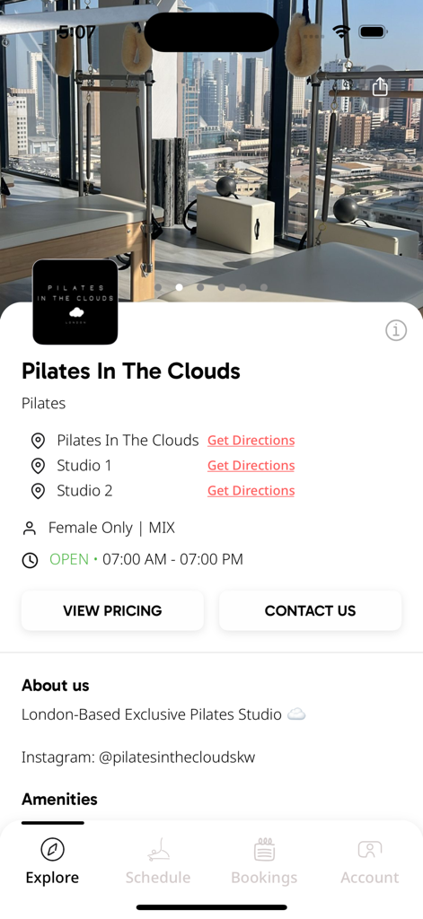 Pilates In The Clouds - The Pilates In The Clouds mobile app interface showing studio locations, opening hours, and pricing options against a luxury studio backdrop with city views.