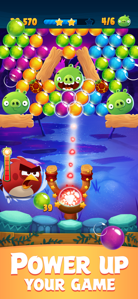 Angry Birds POP! - Angry Birds POP gameplay showing a glowing power up bubble in the slingshot targeting green pigs and colorful bubbles