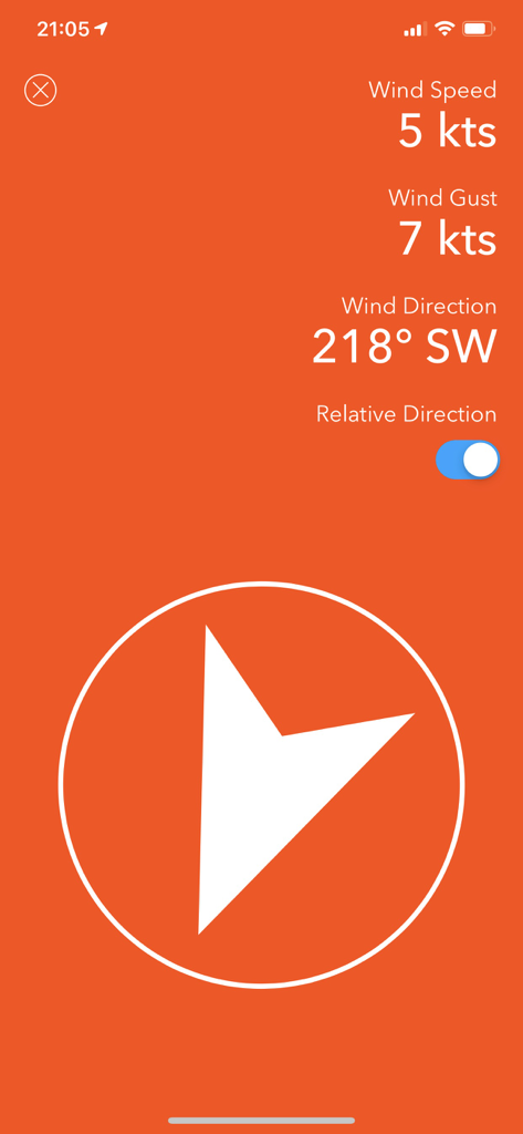 Windsock app interface displaying wind speed in knots, gust speed, and wind direction with a compass arrow on an orange background.