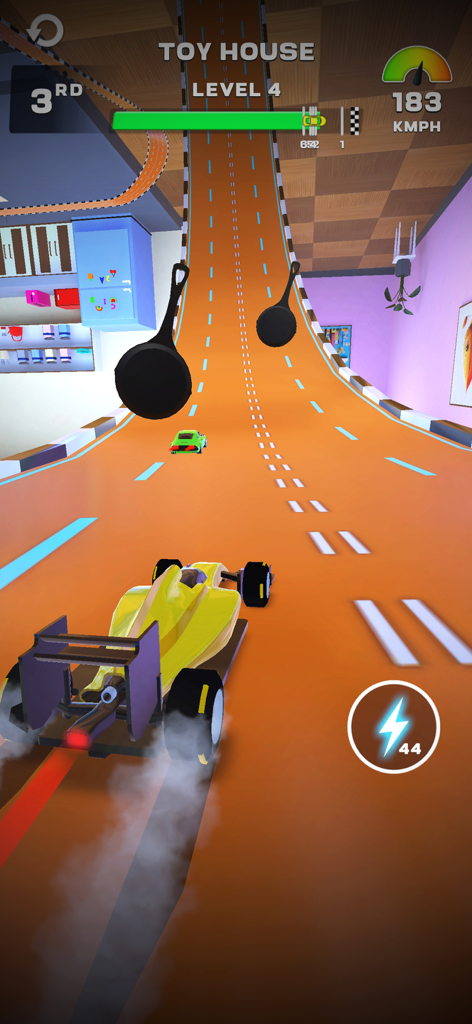 MR RACER : Stunt Mania - A yellow racing car on an orange track in a toy house themed level with flying frying pan obstacles