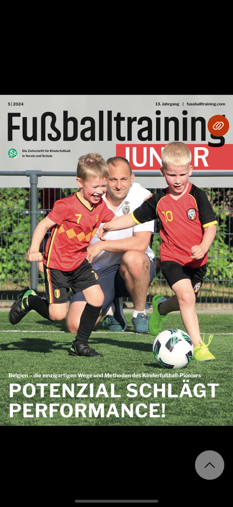 Cover of the Fussballtraining Junior magazine featuring young soccer players and their coach during a training session on a soccer field.