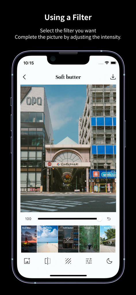 Screenshot of the FilmN app showing the Soft butter filter applied to a city travel photo with an intensity slider and filter carousel.