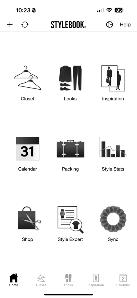 La pantalla de inicio de la aplicación Stylebook Men mostrando iconos para gestión de armario, looks, equipaje y estadísticas de estilo