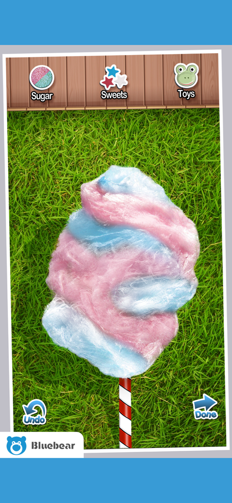Cotton Candy!  - Maker Games - Un algodón de azúcar rosa y azul arremolinado en un palo en una interfaz de juego móvil