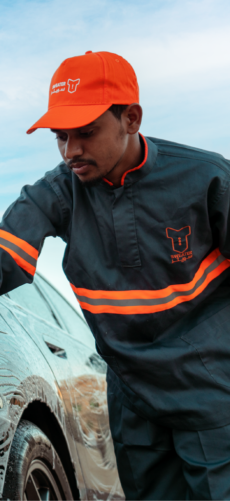 Sweater | Car Wash - A professional car washer in a Sweater uniform cleaning a car outdoors