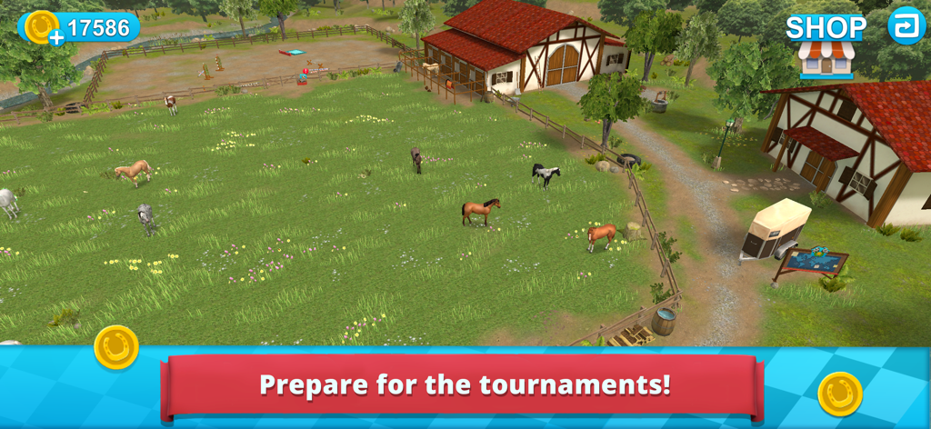 Top down view of a horse ranch with several horses in a green field next to stables