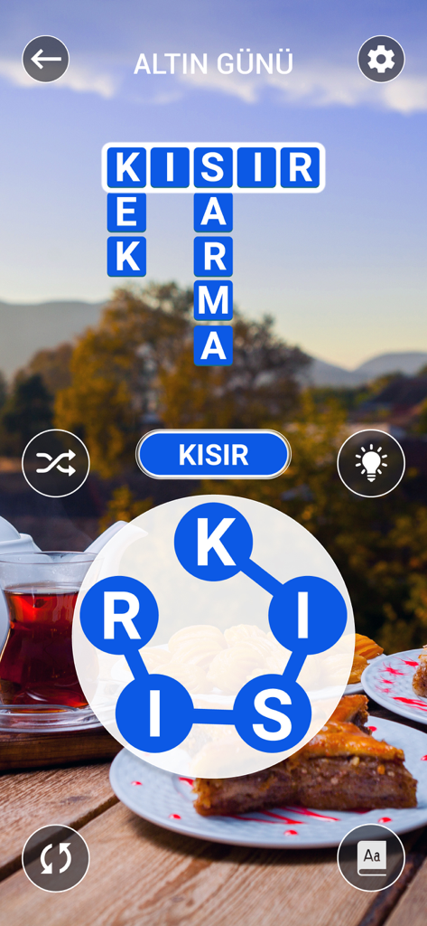 Kelime Gezmece - Kelime Gezmece mobile word puzzle gameplay featuring a crossword grid and Turkish travel themed background with tea and baklava.