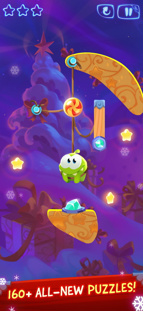 Om Nom hanging from a rope in a magical winter themed puzzle level with candy and stars