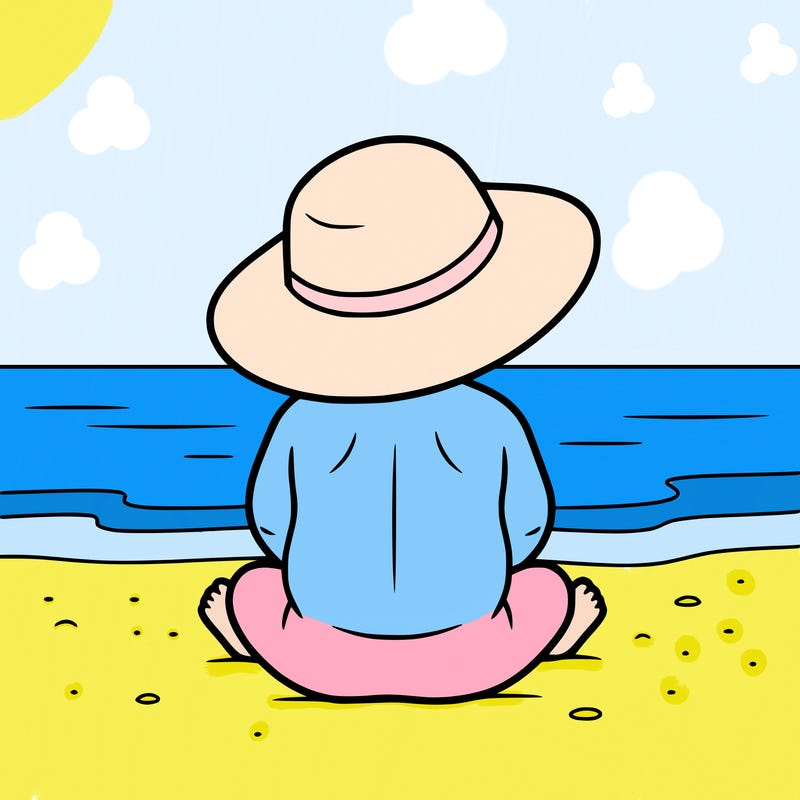 baby on the beach wearing a sun hat