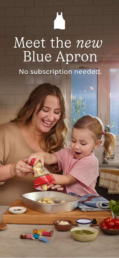Blue Apron: Meal Kit Delivery - A mother and daughter smiling while preparing a Blue Apron Assemble and Bake meal together in their kitchen.