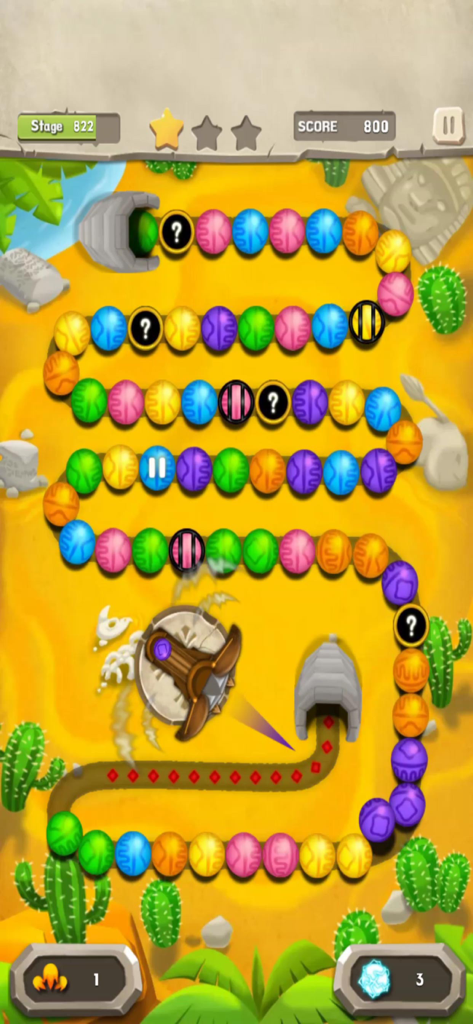 Colorful marble shooter puzzle gameplay in a desert themed level.