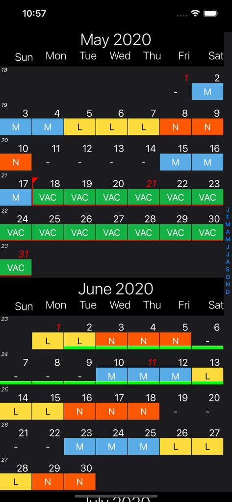 Vista mensual de la aplicación Shift Calendar Pro que muestra turnos de trabajo codificados por colores y días de vacaciones en una interfaz de tema oscuro.