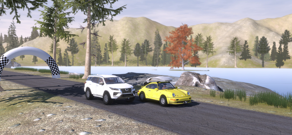 Two offroad vehicles driving on a scenic mountain road next to a lake