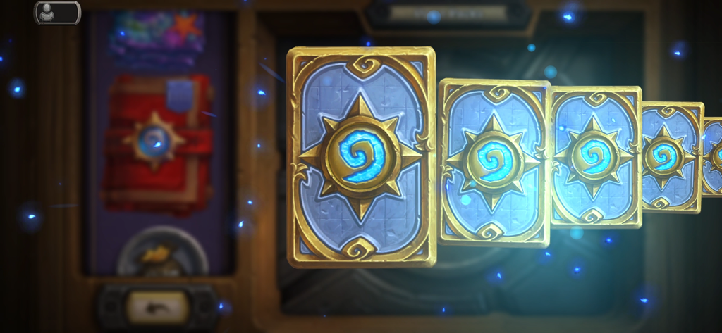 A fan of Hearthstone card backs glowing during a pack opening