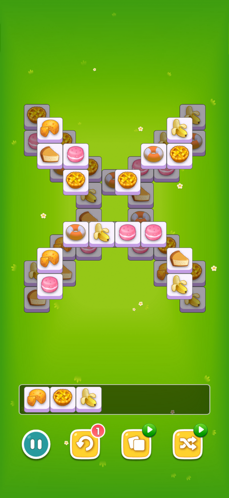 Triple Tile Puzzle- Connect 3 - Jugabilidad de Triple Tile Puzzle con fichas de comida y frutas sobre un fondo de prado verde