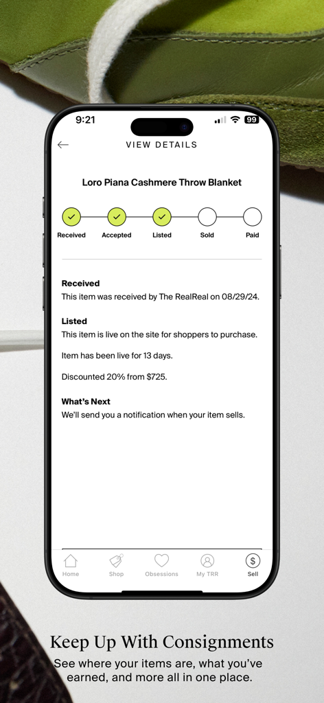The RealReal app interface showing the status of a consigned Loro Piana cashmere blanket from received to listed.