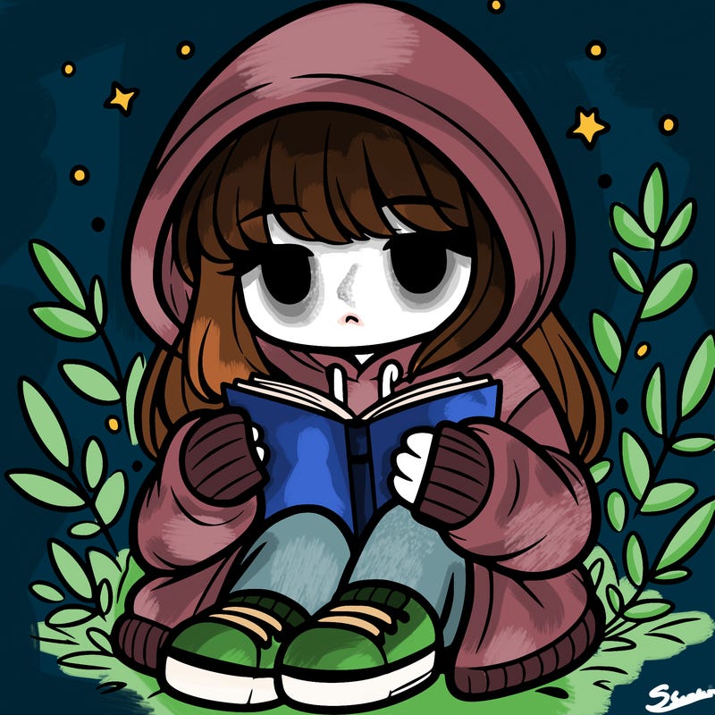 girl in oversized hoodie reading a book