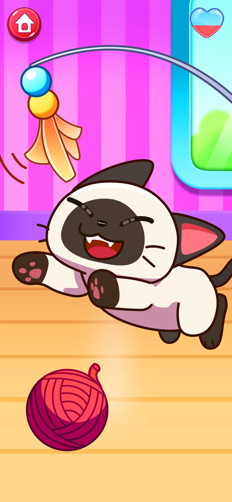 Cat Games for kids - Un feliz gato siamés jugando con un ovillo de lana y un juguete en la aplicación Juegos de Gatos para niños.