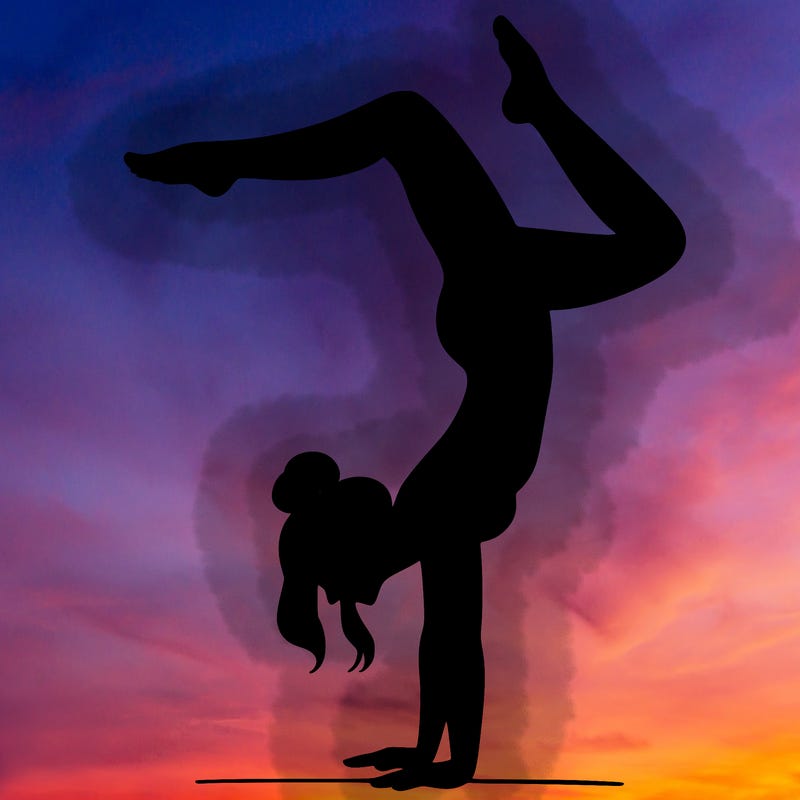 a woman doing a handstand